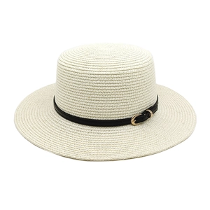 Detailed weave of cream flat top straw hat with black leather band and gold metal buckle