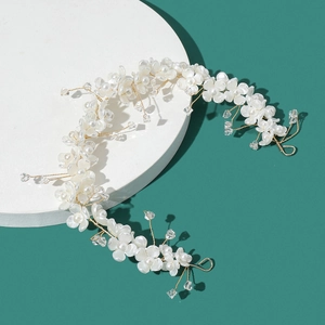 Elegant bridal floral headband with white clover flowers and crystal beads on a gold wire
