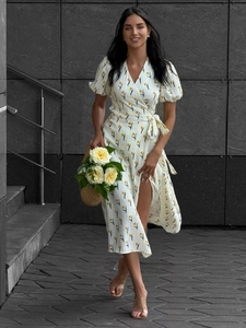 Detail of white cotton floral wrap dress with puff sleeves and yellow tulip pattern