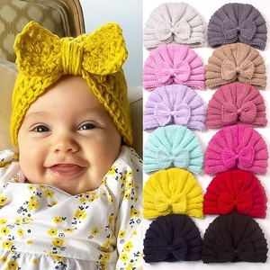 Baby knitted beanie hat with bow detail available in thirteen warm colors for infants