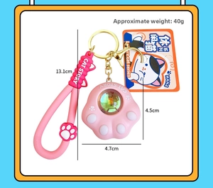 Detailed close-up of pink cat paw keychain with silicone strap and metal ring