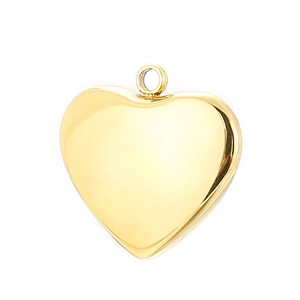Macro detail of polished gold heart pendant made of smooth stainless steel jewelry metal