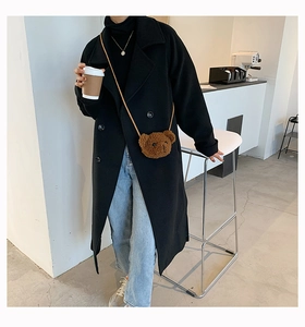 Brown teddy bear plush crossbody bag styled with a black wool coat and blue jeans
