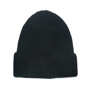 Detailed view of black ribbed knit beanie featuring a classic wide cuff and textured fabric
