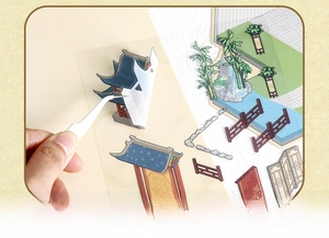 Detail of thickened white ink 3D Chinese garden stickers being applied with tweezers