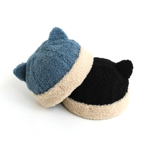 Detail view of thick Sherpa-lined corduroy sailor beanies in black and navy blue colors