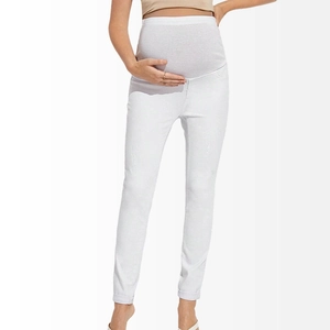 Close-up of white maternity skinny jeans with a soft grey elastic belly band