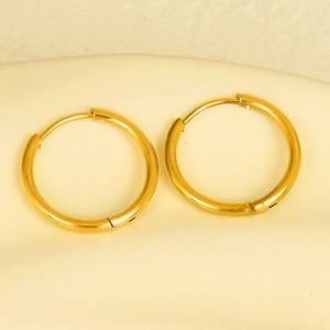 Close-up of golden stainless steel hoop earrings with secure click closure