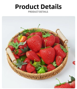Close-up of realistic artificial strawberries in a woven rattan basket with wooden handles