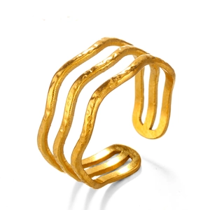 Minimalist 3-layer wave ring in gold finish with hammered texture on white background