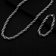 Detailed close-up of a silver twist rope chain necklace and bracelet jewelry set