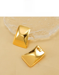 Detailed close-up of 18K gold-plated rectangular earrings with a smooth concave design
