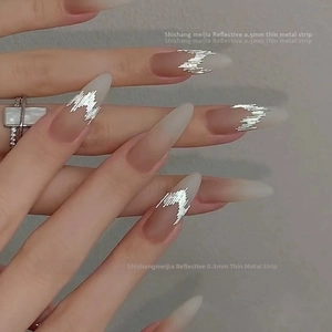 Detail of 0.5mm reflective silver metal strips for nail art on a model's hand