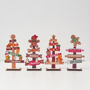 Detail of four wooden Christmas tabletop decorations with gingerbread and snowman motifs