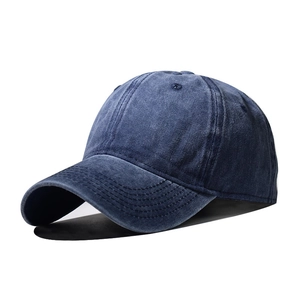 Close-up of washed navy blue cotton baseball cap showing vintage texture and stitching