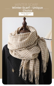 Close-up of brown and white houndstooth cashmere-like scarf with fringe on a mannequin