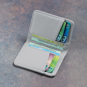 Close-up of gray leather wallet interior with multiple card slots and clear ID window