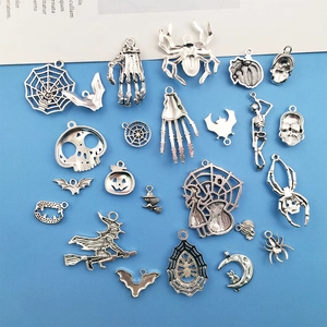 Detailed assortment of silver Halloween charms including spiders, skulls, and pumpkins