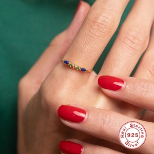 Close-up of S925 silver ring with turquoise and colorful gems on a model's hand