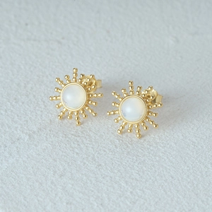 Detail of 925 silver sunburst stud earrings with opal stone and golden beaded rays