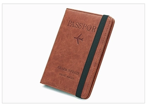 Brown leather passport holder with embossed text and elastic band for travel security