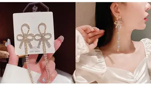 Close-up of S925 silver needle tassel earrings with gold-tone bow and sparkling crystals