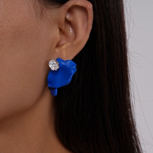 Close-up of klein blue matte petal earring with a sparkling round zircon stone