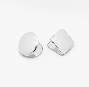 Macro shot of round and square stainless steel folding pocket mirrors in silver finish