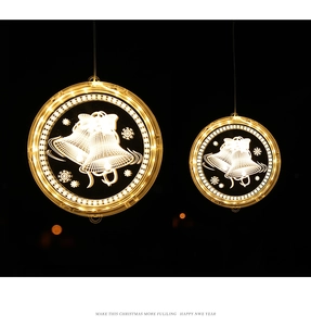Detail of round 3D acrylic LED Christmas lights featuring warm white bell and snowflake patterns