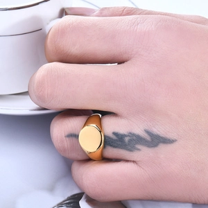 Minimalist gold plated stainless steel signet ring with a round blank polished surface