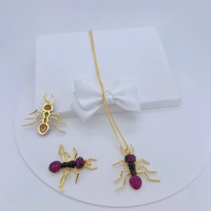 Detailed macro view of ant-shaped jewelry set with micro-set purple and black zircons