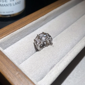 Détail d'un ear cuff étoile argentée avec zircons et perles sur un écrin à bijoux gris