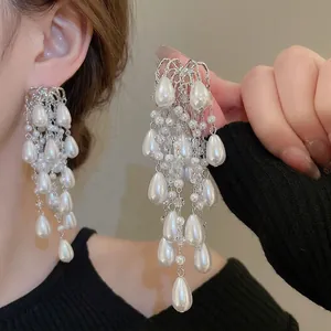 Elegant long silver tassel earrings with white pearls and teardrop beads in a luxe style