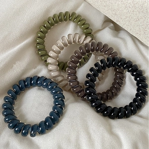 Set of 5 spiral telephone cord hair ties in Morandi colors on silk fabric background
