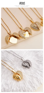 Close-up of heart-shaped opening pendant with wing design and sparkling zircon stones