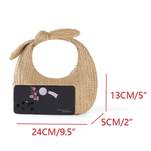 Women's crescent straw handbag with bow handle and phone size comparison for scale
