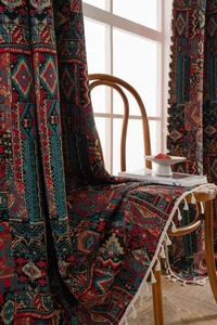 Detail of bohemian geometric jacquard curtain fabric with decorative white cotton tassels