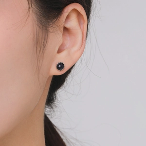 Minimalist S925 silver stud earrings with sparkling black stone on female model