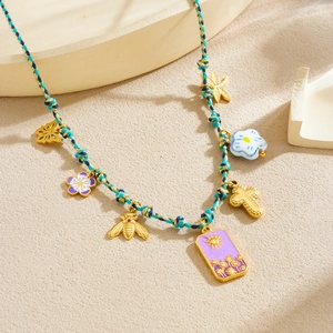 Bohemian braided necklace with sun star bee and flower charms on blue woven cord