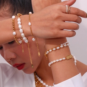 Detail of 18K gold-plated pearl jewelry set featuring a 11:11 engraved tag charm