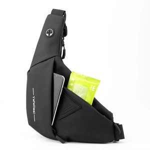 Waterproof black crossbody chest bag showing internal capacity with phone and wipes