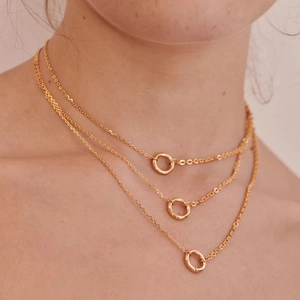 Close-up of triple-layered 18K gold-plated stainless steel necklace with ring pendants