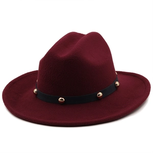 Detail of burgundy wool fedora hat featuring black ribbon band with gold metal studs