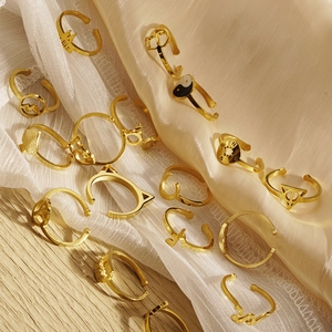 Assorted gold stainless steel adjustable rings with geometric and peace sign designs