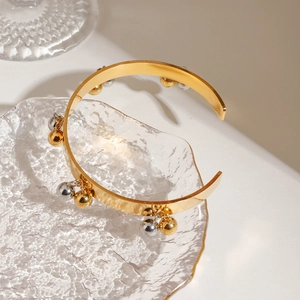 18K gold and silver two-tone stainless steel open bangle featuring polished metal beads