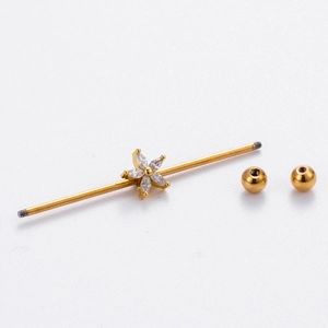 Golden industrial piercing jewelry featuring a sparkling six-petal flower zircon charm