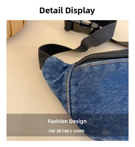 Detailed view of dark blue denim waist bag with yellow stitching and black zipper
