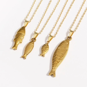 Set of four gold tropical fish pendants in titanium steel with detailed textures on white background