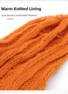 Macro detail of high-density orange knit fabric showing soft texture and warm inner lining