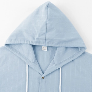 Close-up of linen hooded shirt neckline with vertical stripes and size label